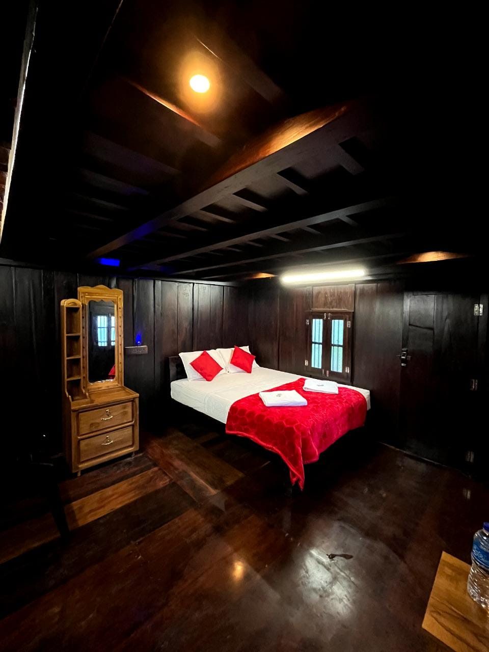 Wood-panelled bedroom with queen bed at Chalet Villa Unit 2