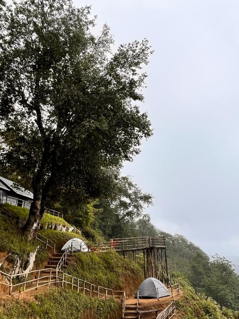 Camp tents and viewing deck in the Vattavada mist